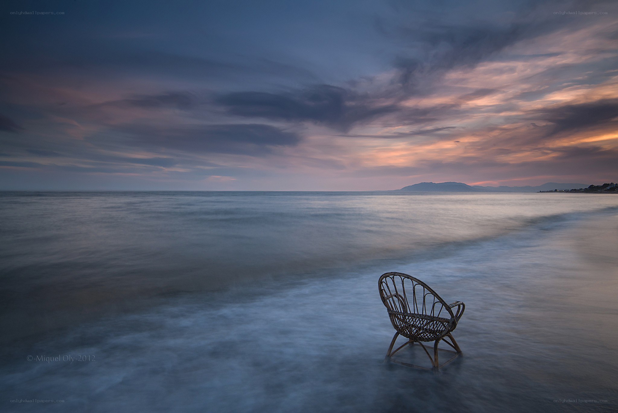 Empty chair on a beach at dusk