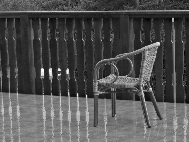 Empty chair on wet patio
