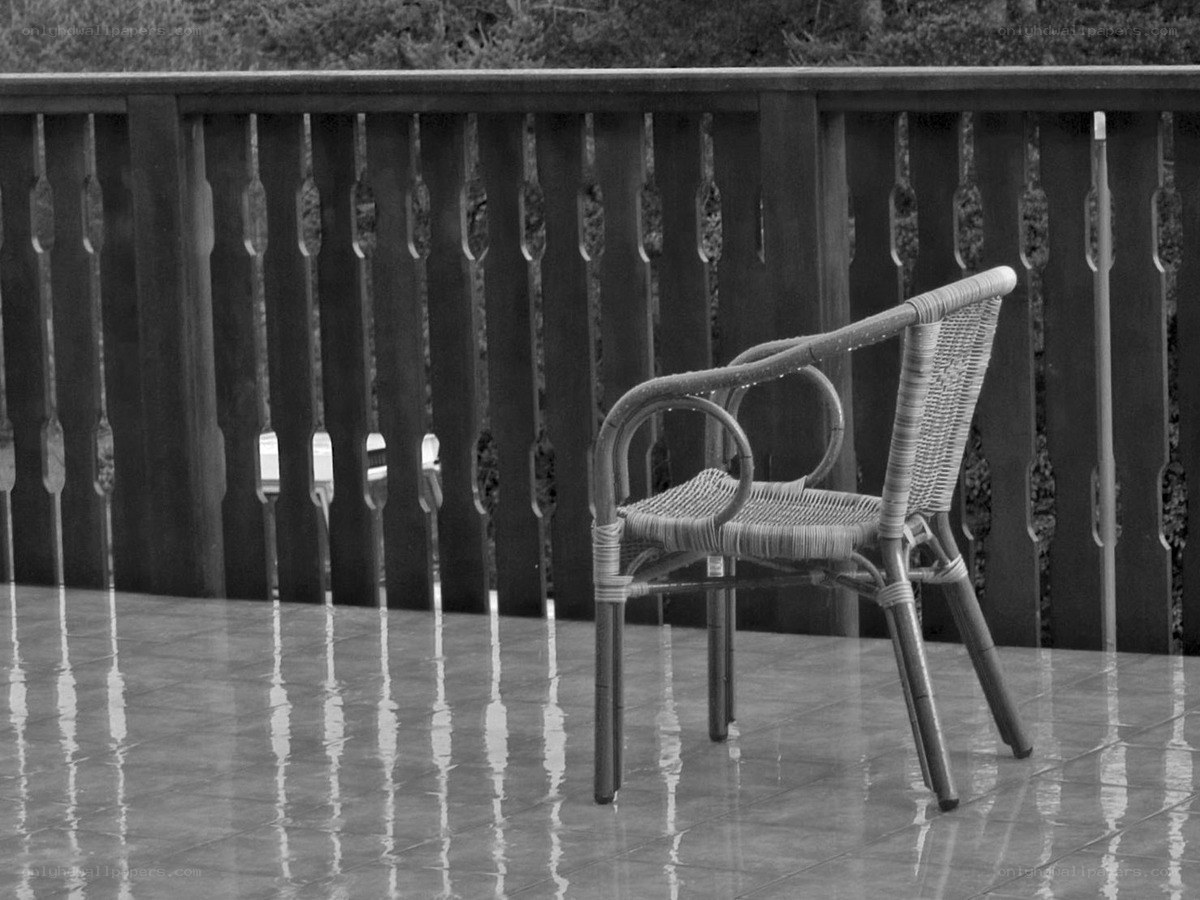 Empty chair on wet patio