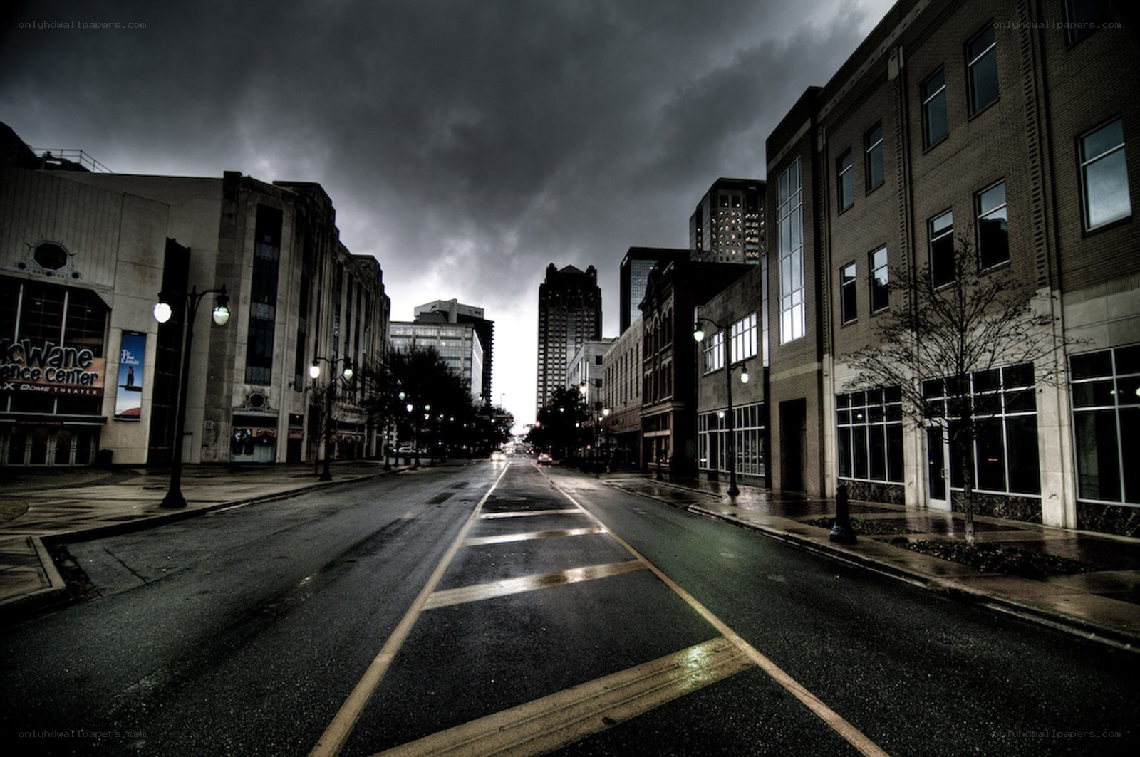 Empty city street under stormy sky
