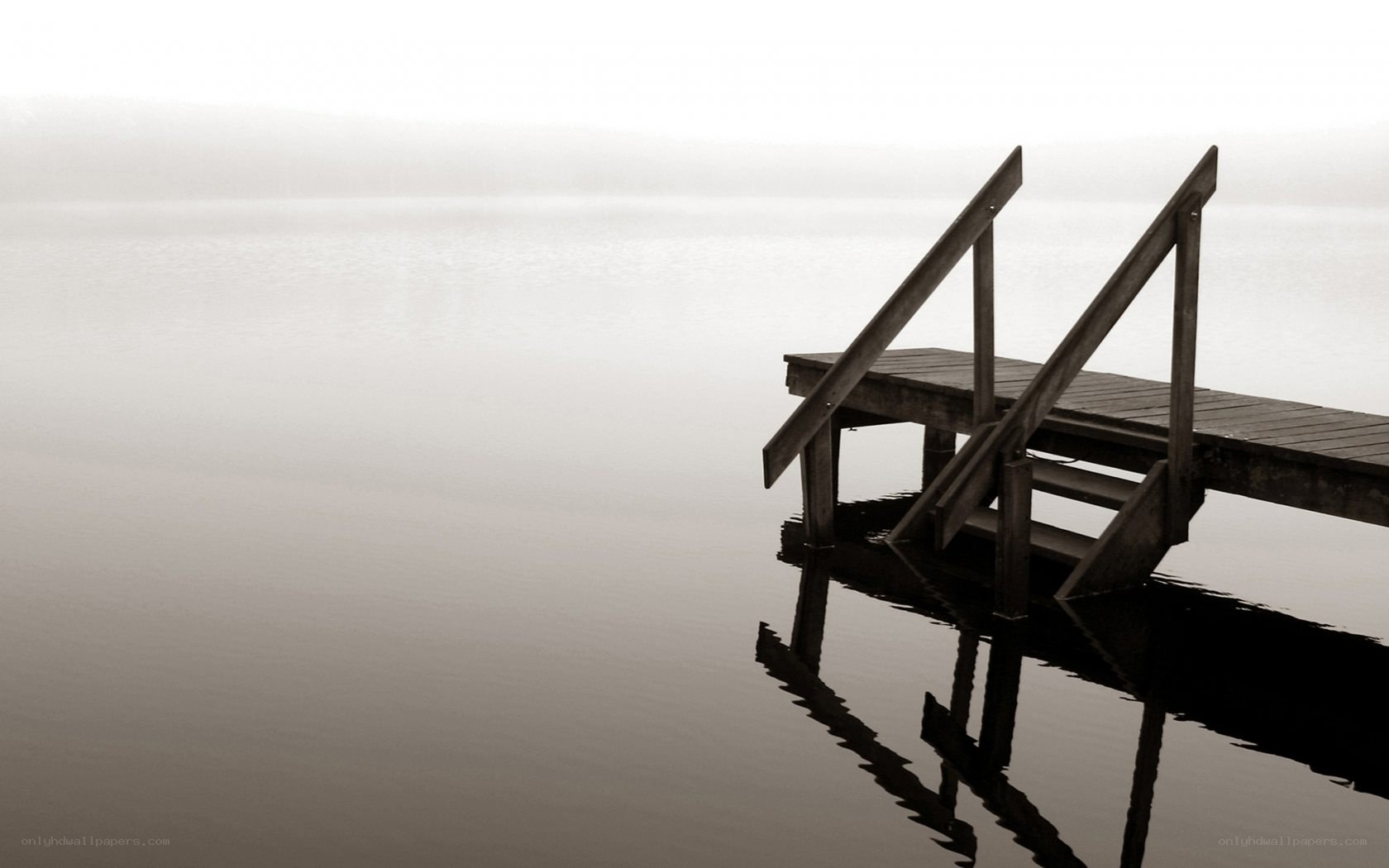 Empty dock on a foggy lake