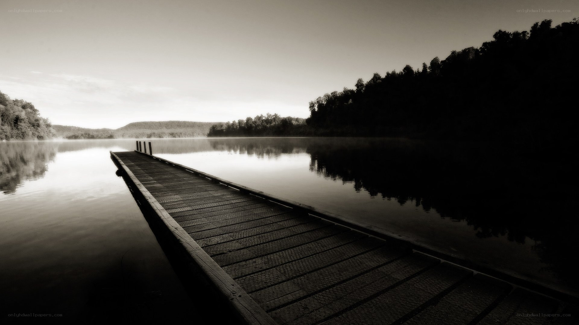 Empty dock on a misty lake