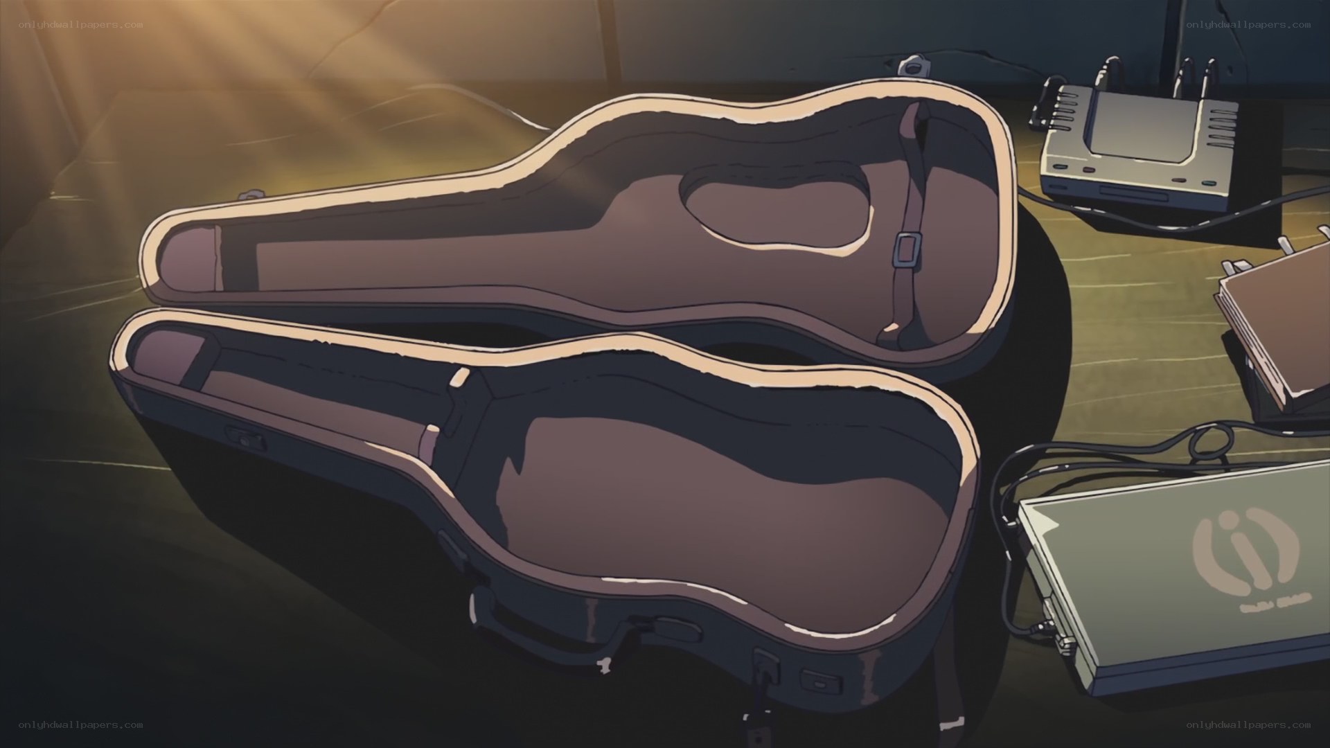 Empty guitar case in dim light