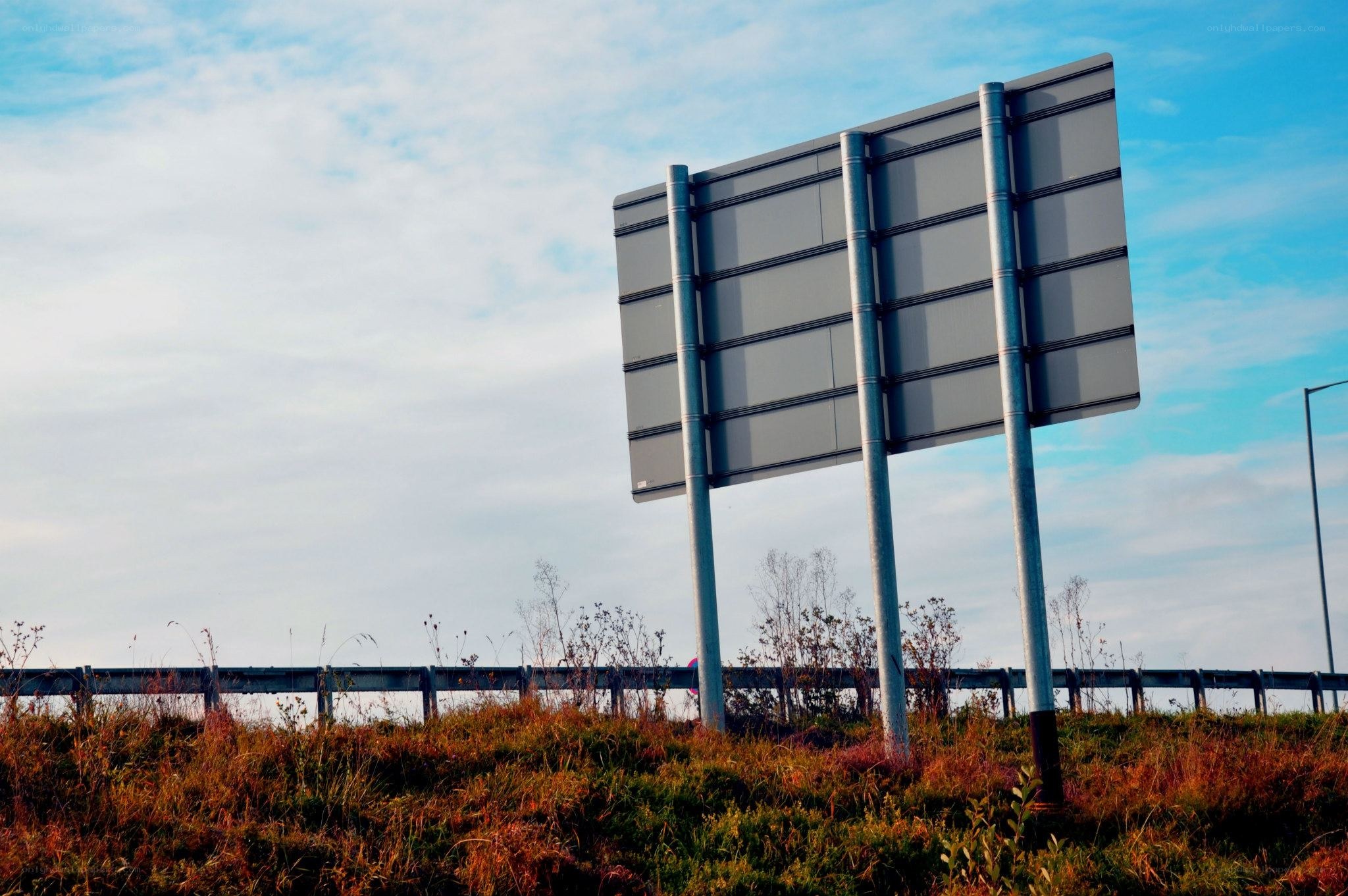 Empty highway sign on a hill