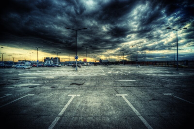 Empty parking lot under stormy sky