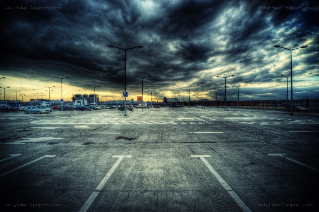 Empty parking lot under stormy sky