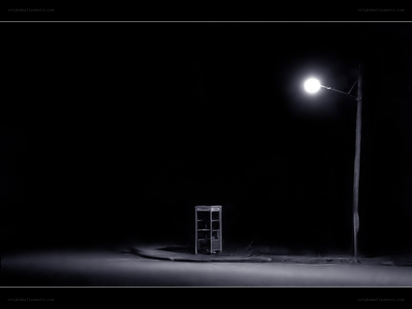 Empty phone booth under streetlight