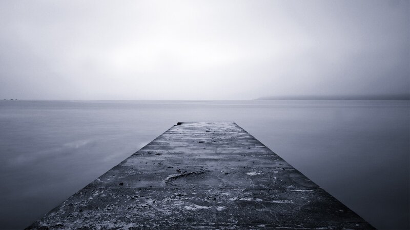 Empty pier on a foggy day