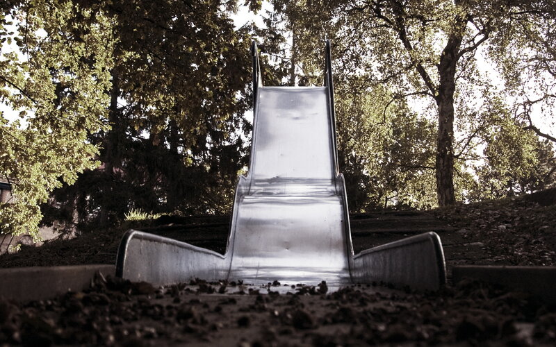 Empty playground slide in forest
