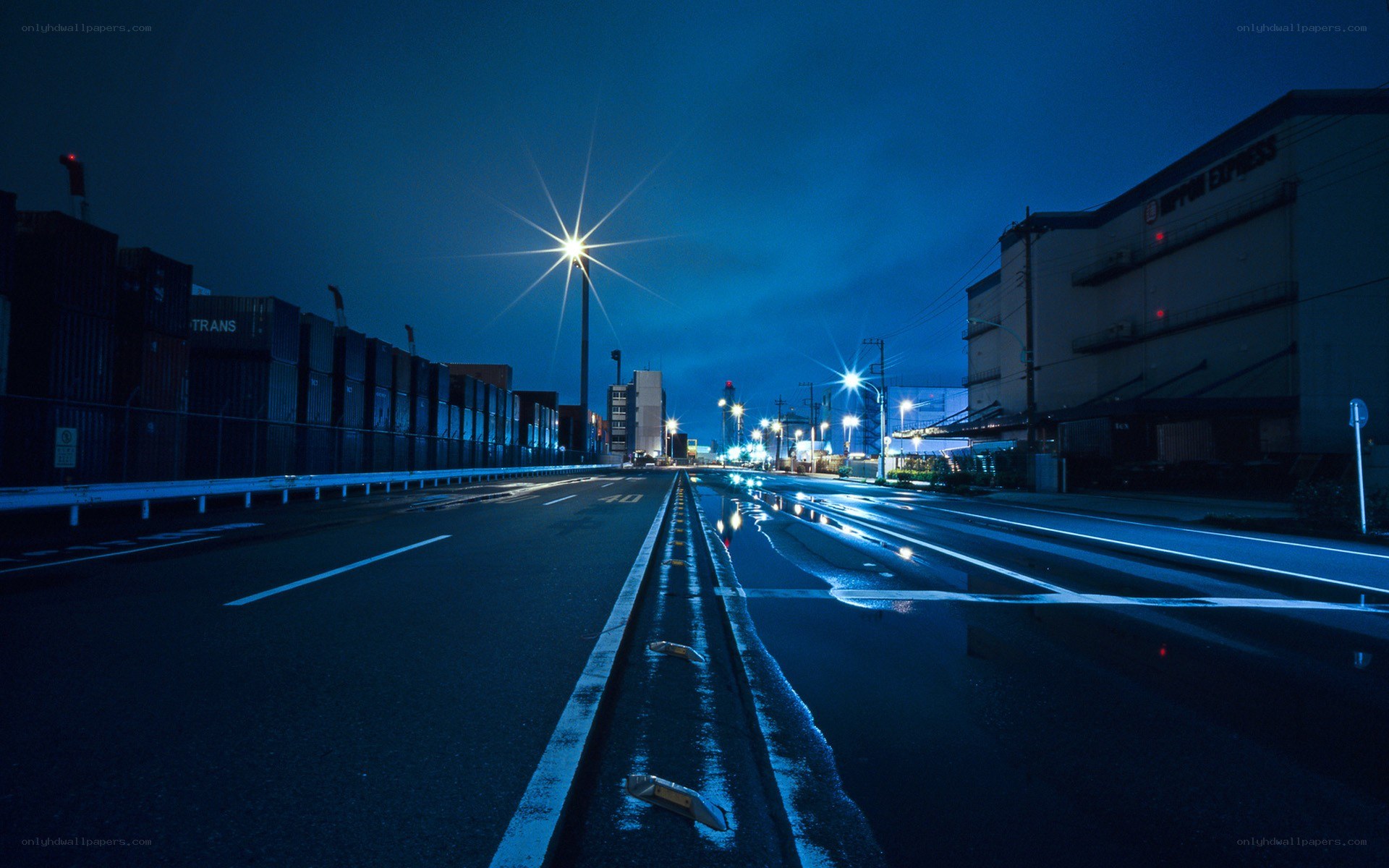 Empty road at night in industrial area