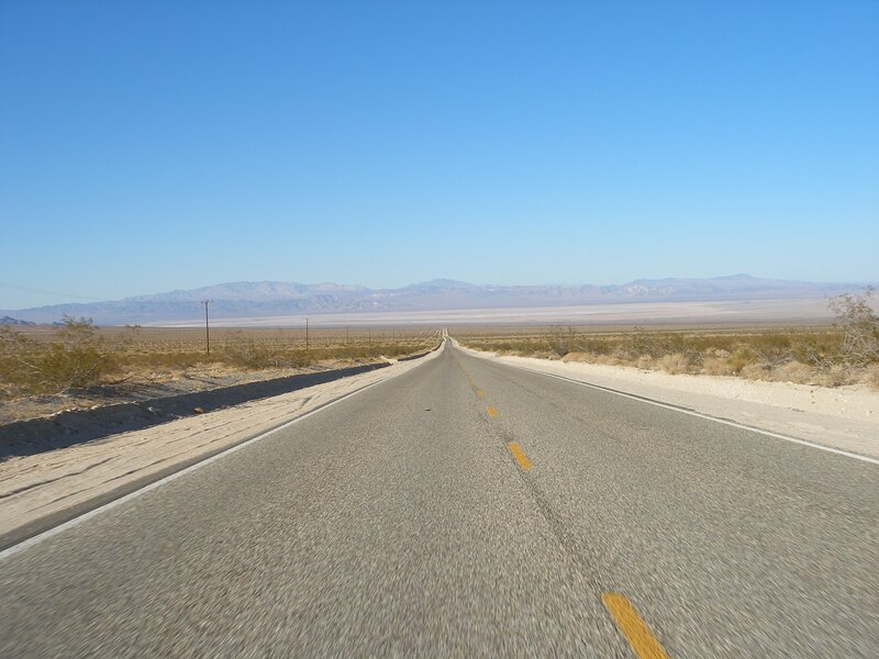 Empty Road in Desert — Blue, Serene, Afternoon, Photograph, Mountains, Power Lines