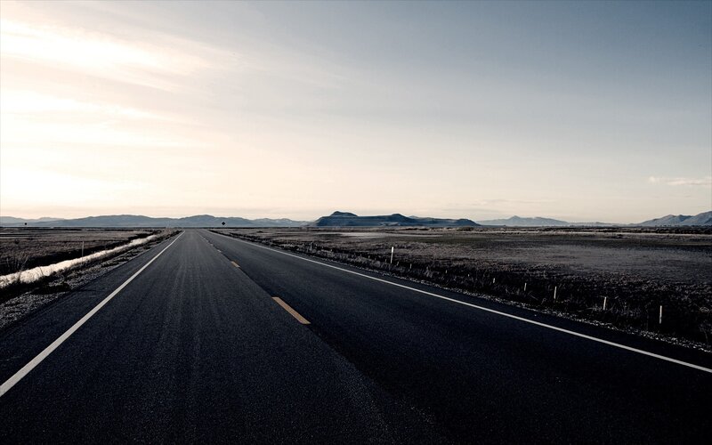 Empty road in open landscape