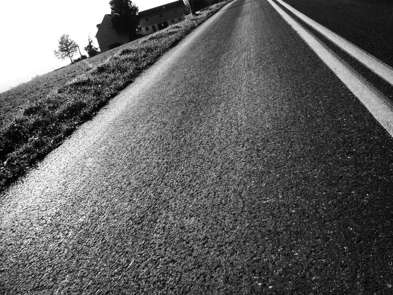 Empty road leading to houses