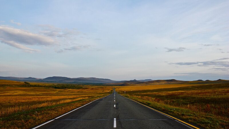 Empty Road Through Grassland