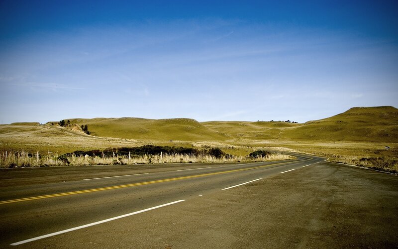 Empty road through rolling hills