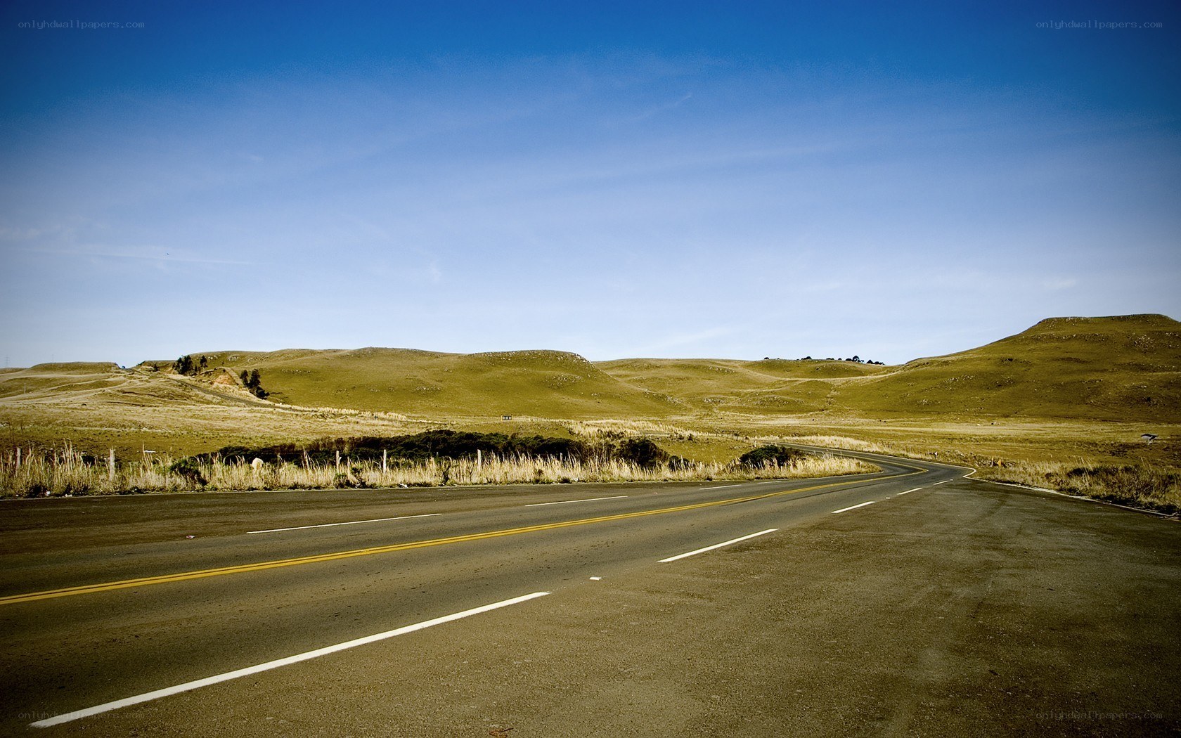 Empty road through rolling hills
