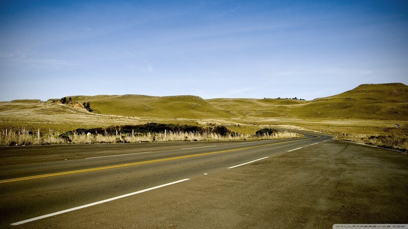 Empty road through rolling hills