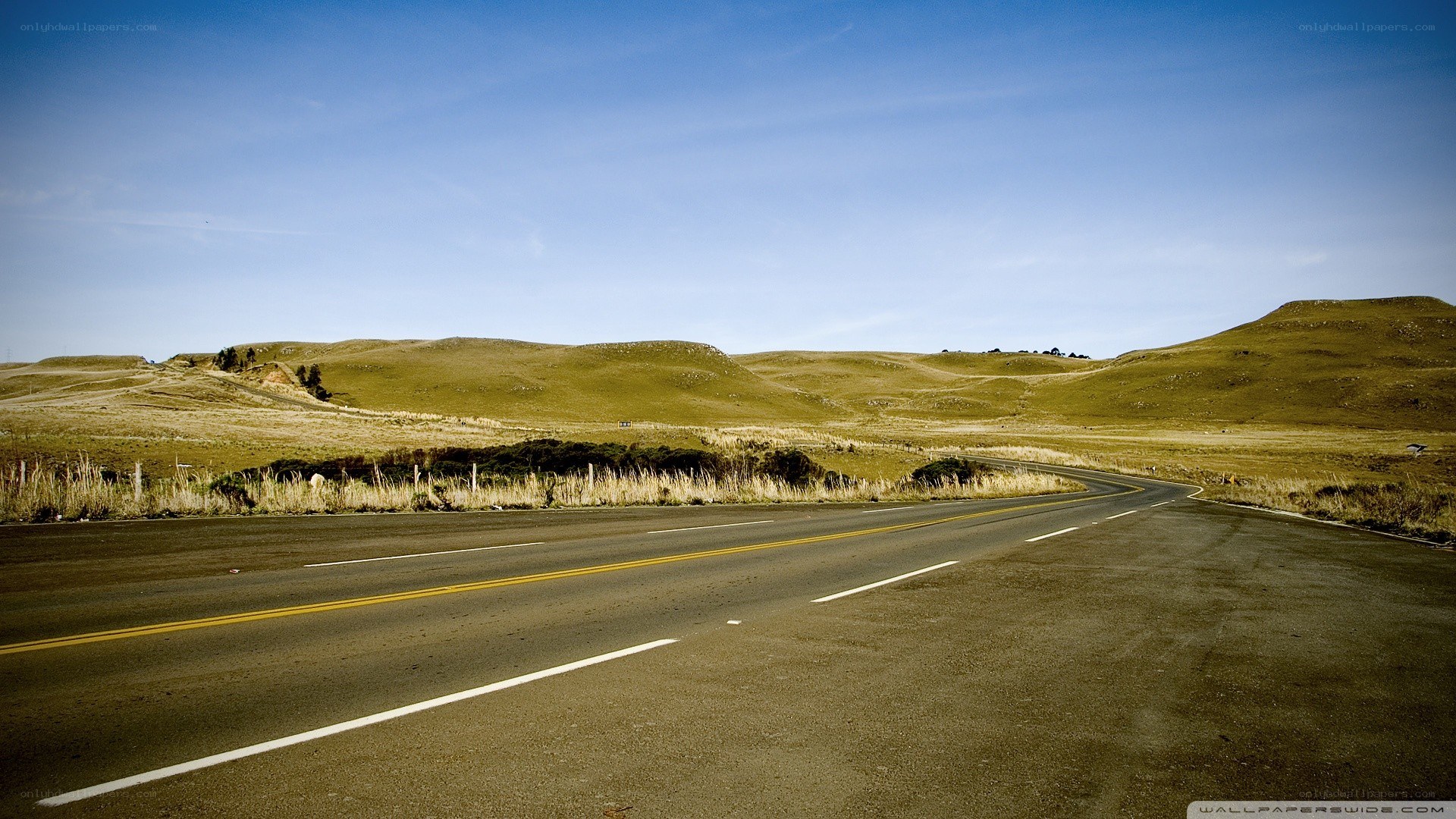 Empty road through rolling hills