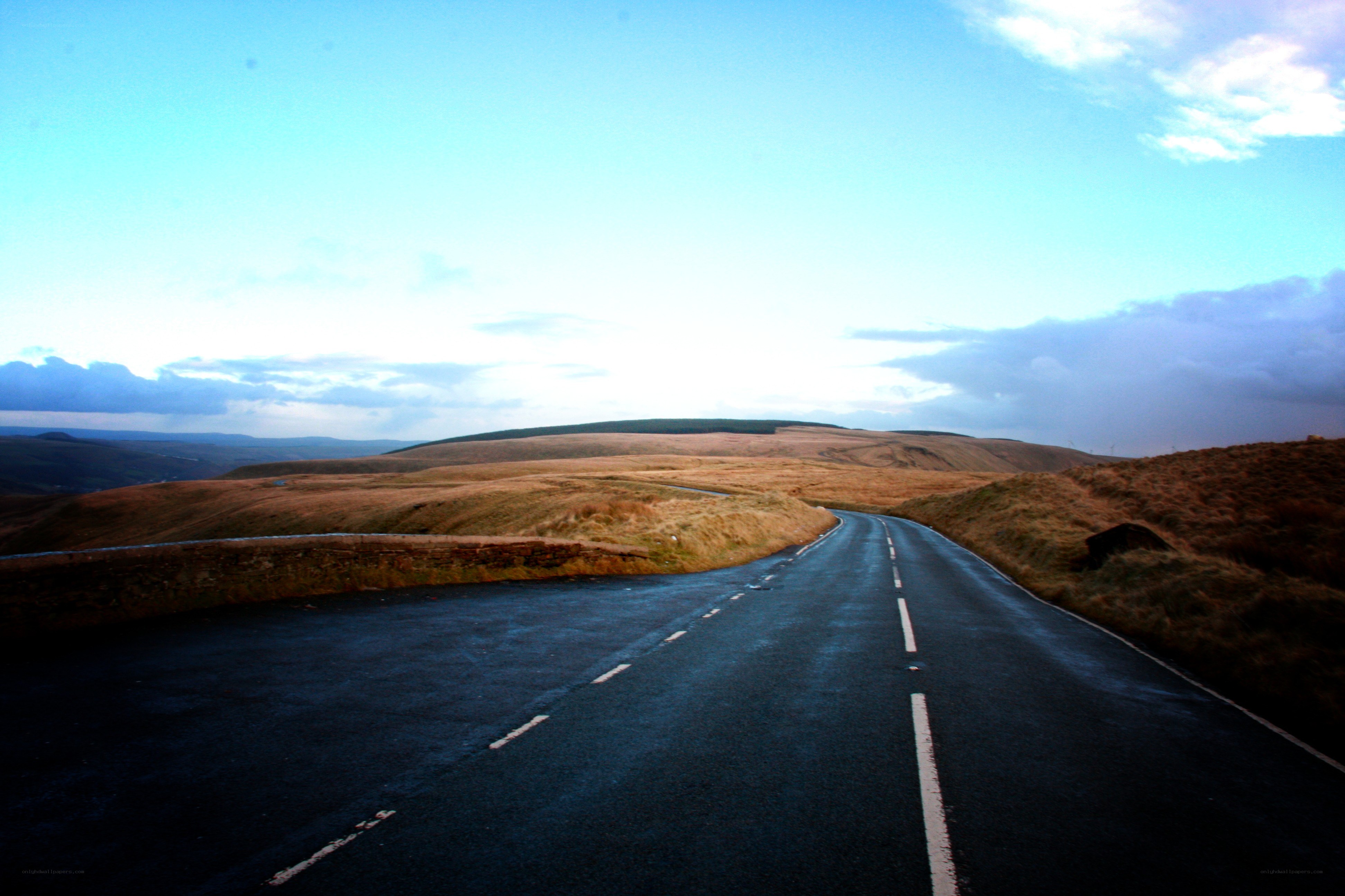 Empty road through rolling hills