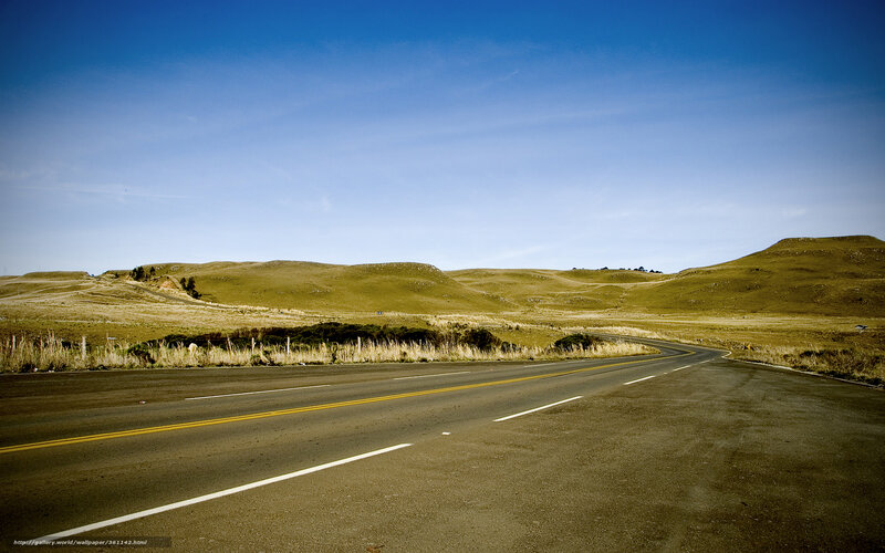 Empty road through rolling hills