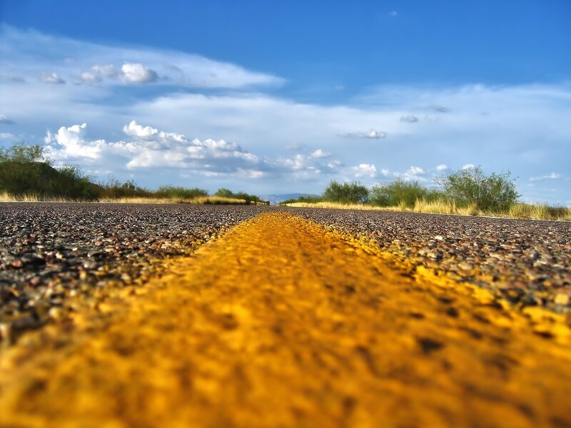 Empty road under blue sky