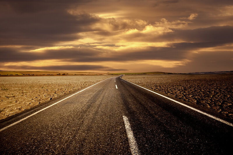 Empty road under golden sky