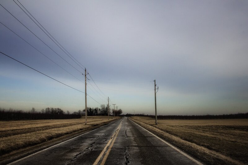 Empty road under overcast sky