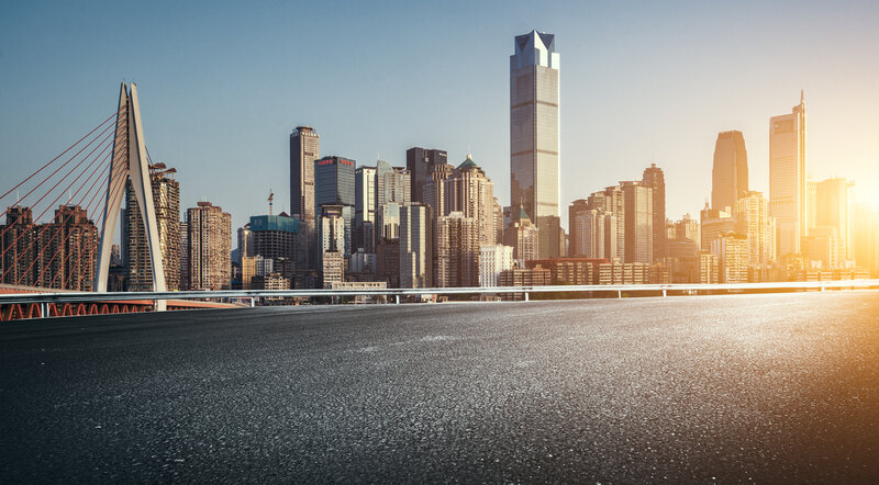 Empty Road with City Skyline