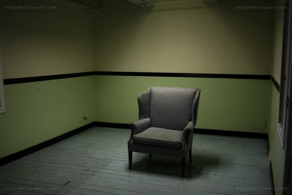Empty room with a single armchair