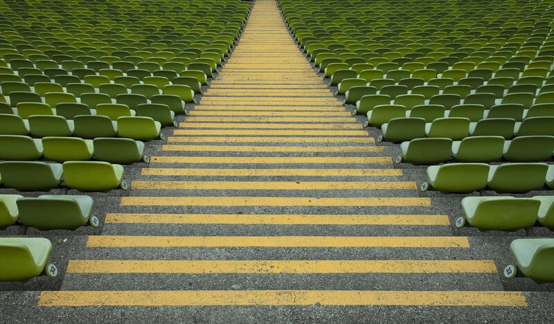 Empty stadium seats and yellow steps