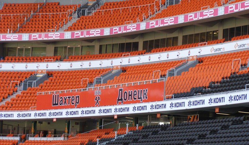empty stadium seats with advertisements