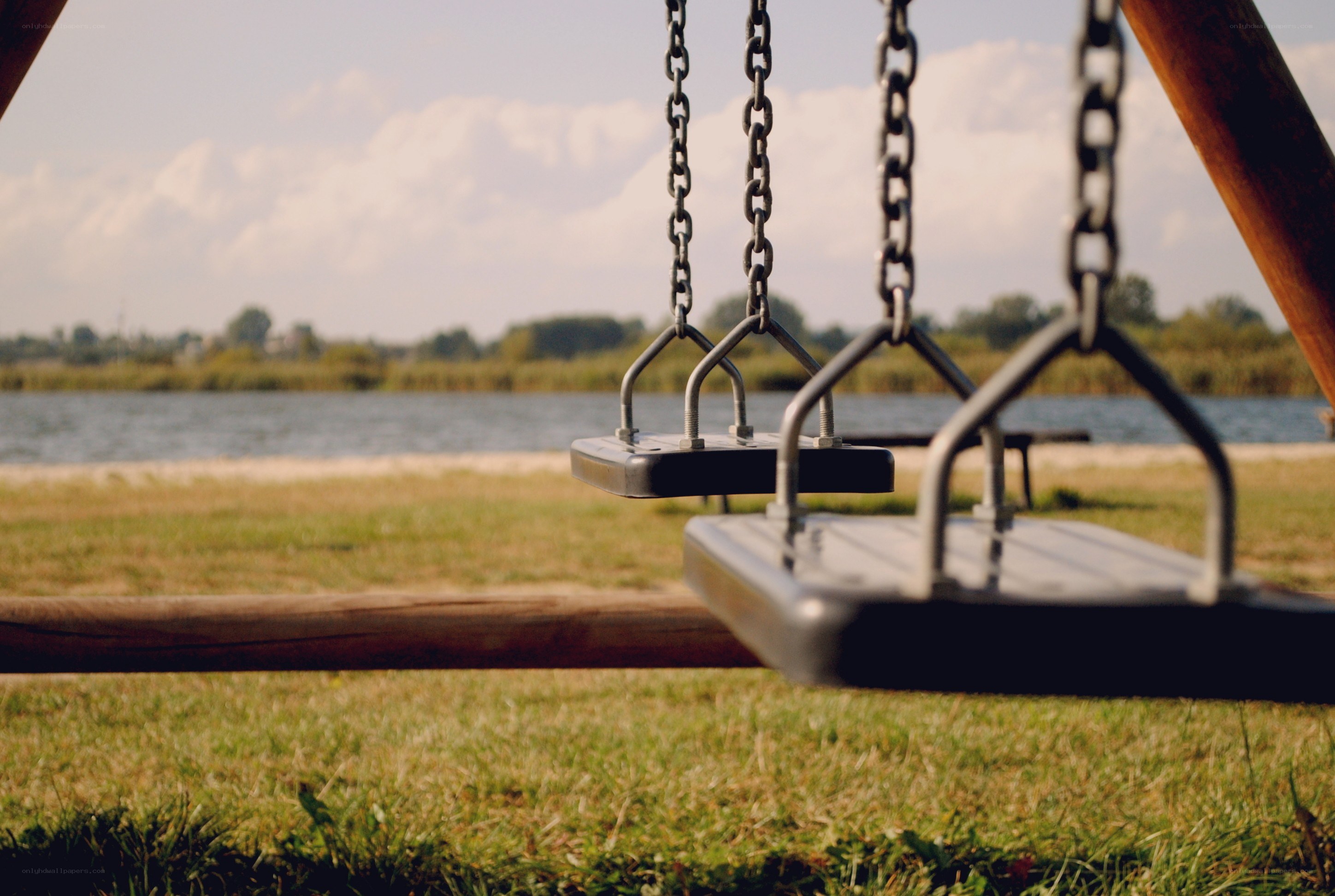 Empty swings by the lake