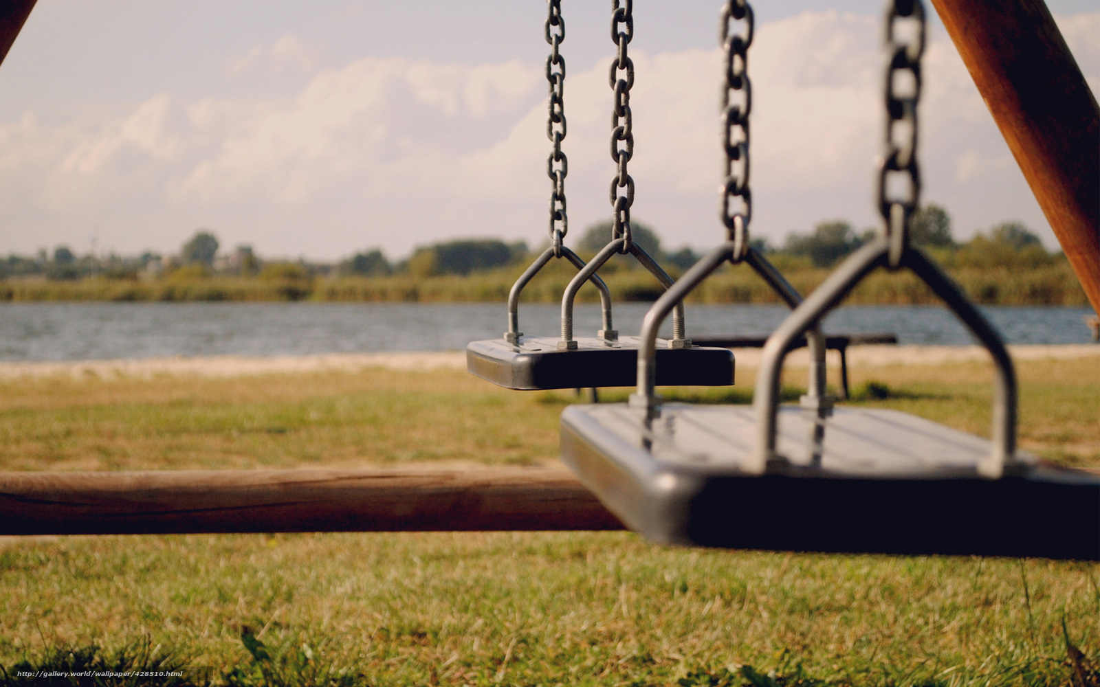 Empty swings by the lake