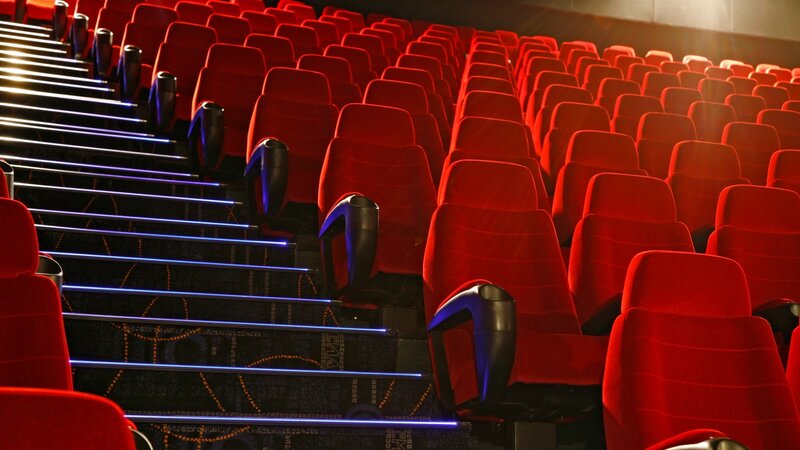 Empty theater seats in dim light