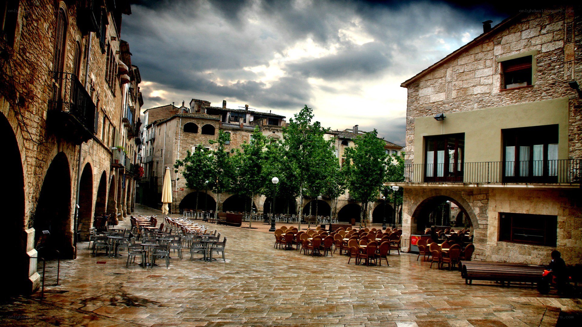 Empty town square under stormy sky