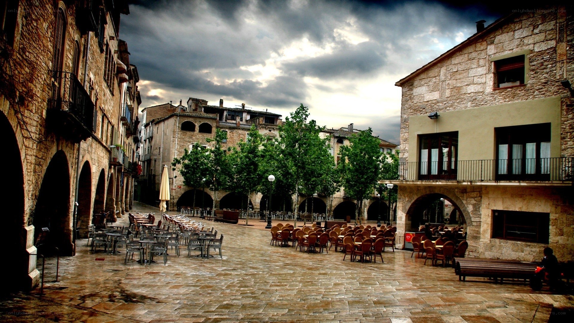 Empty town square under stormy sky