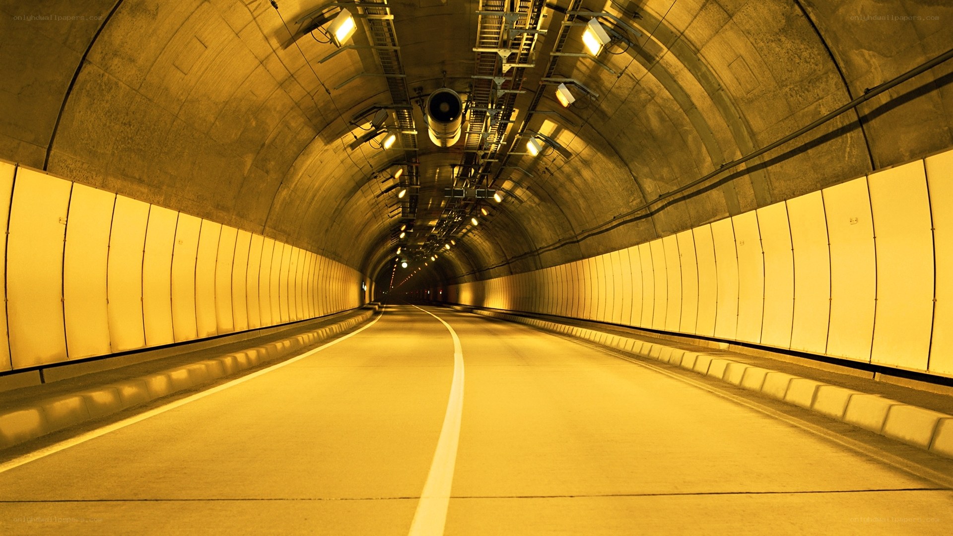 Empty tunnel with yellow lighting