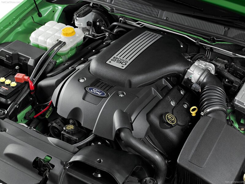 Engine Bay of a Car — Black, Technical, Photograph, Battery, Coolant Reservoir