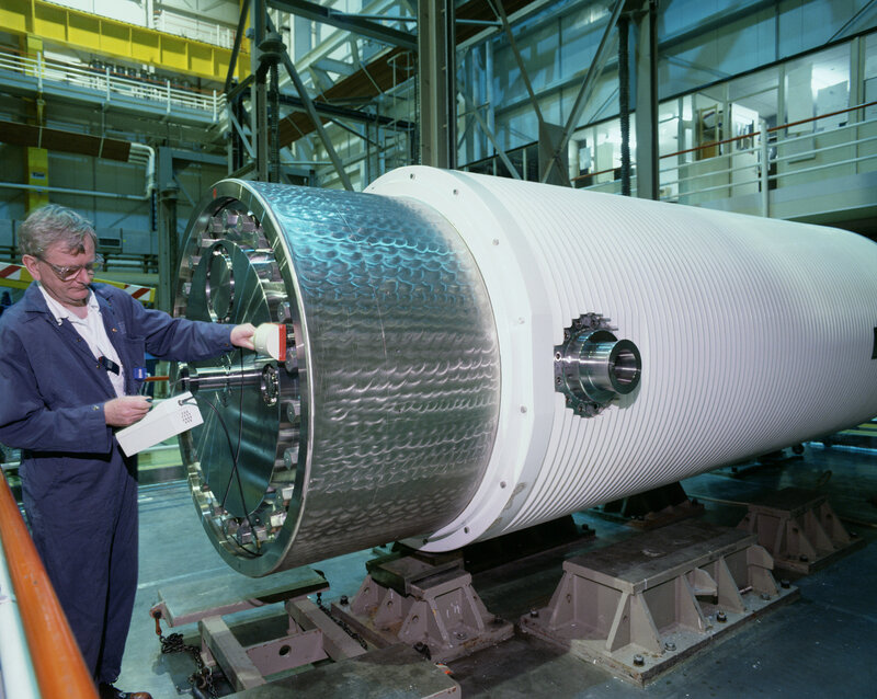 Engineer inspecting large cylinder