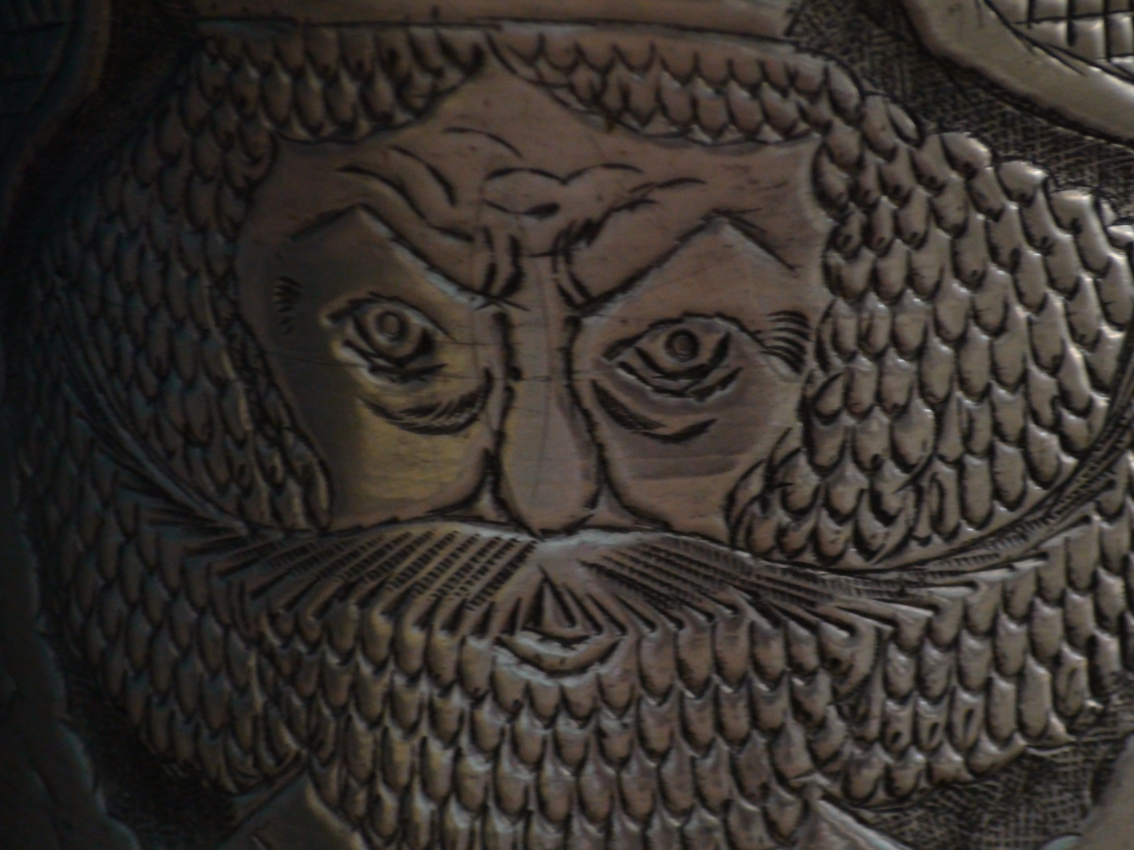engraved face on metal