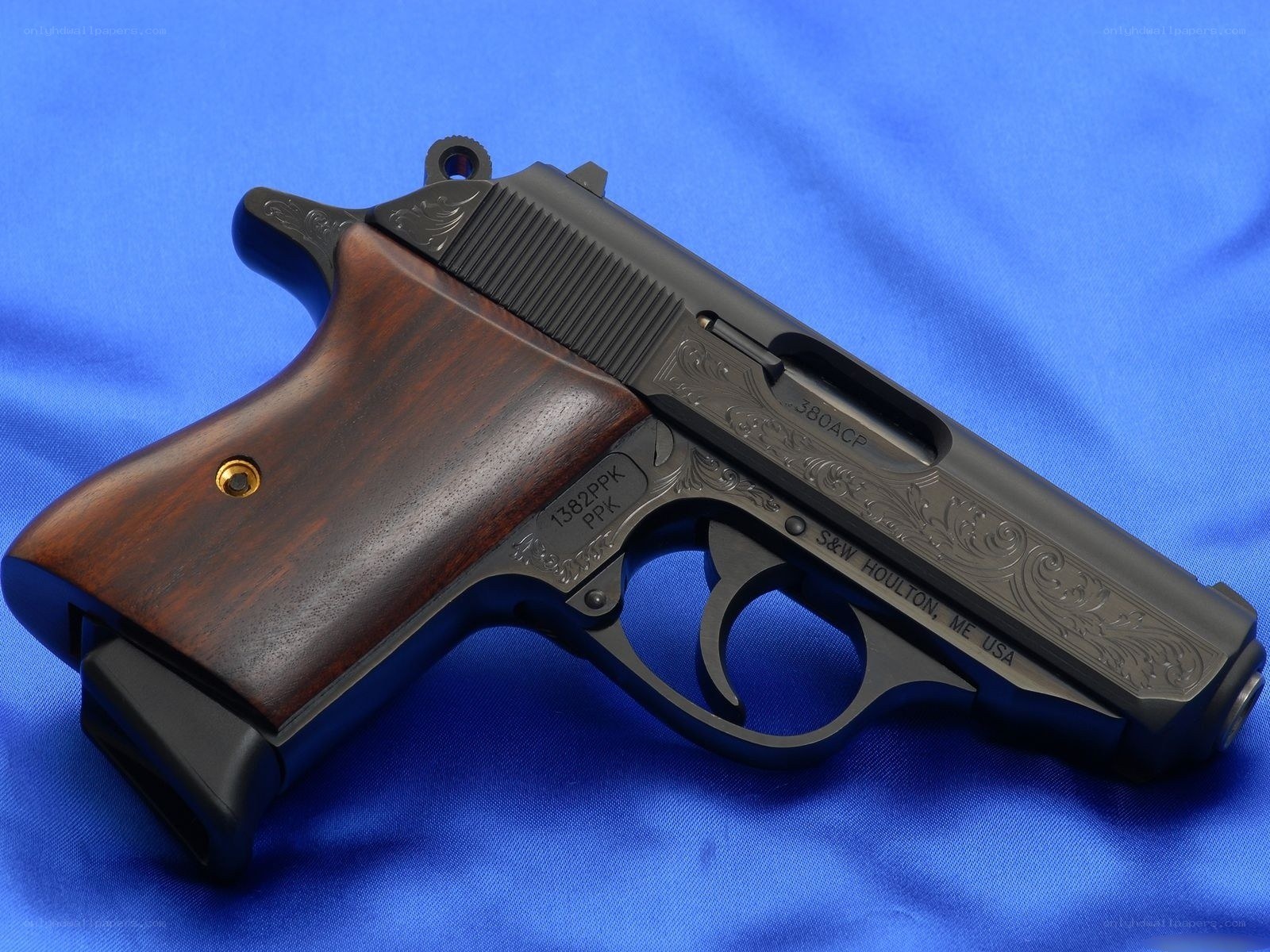 engraved pistol on blue