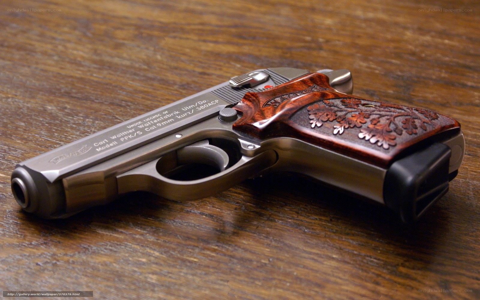 engraved pistol on wood