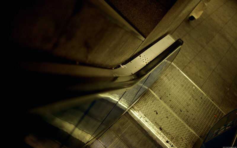 Escalator in dimly lit station