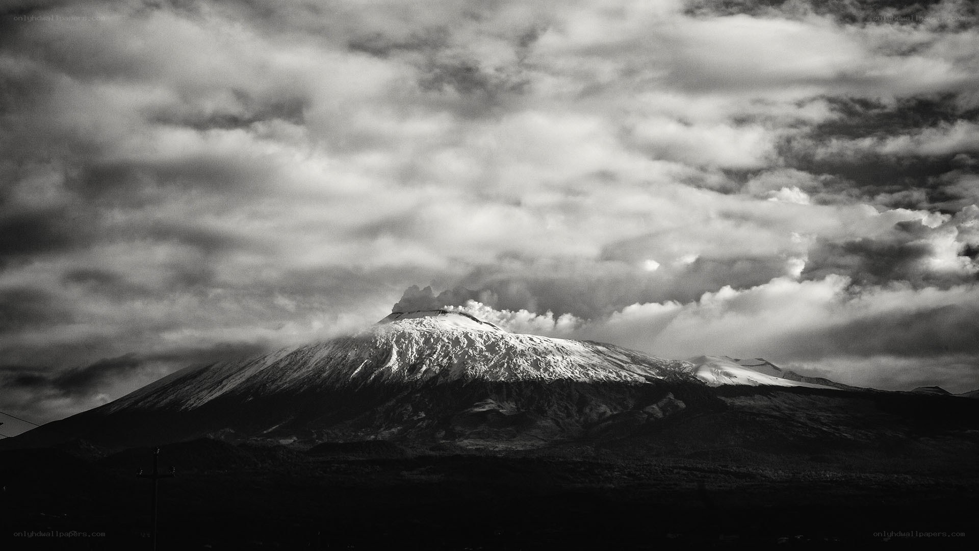Etna volcano under cloudy sky