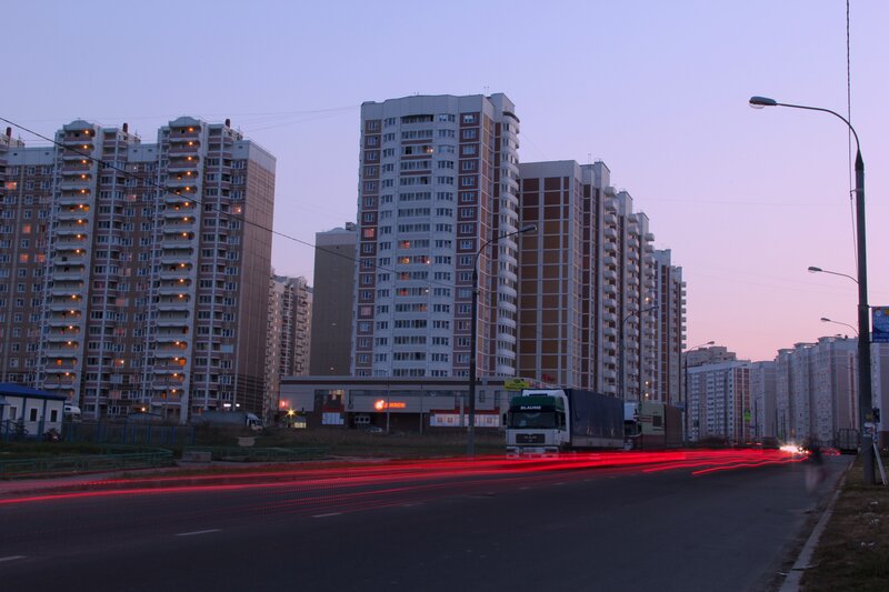 Evening city street with apartment buildings