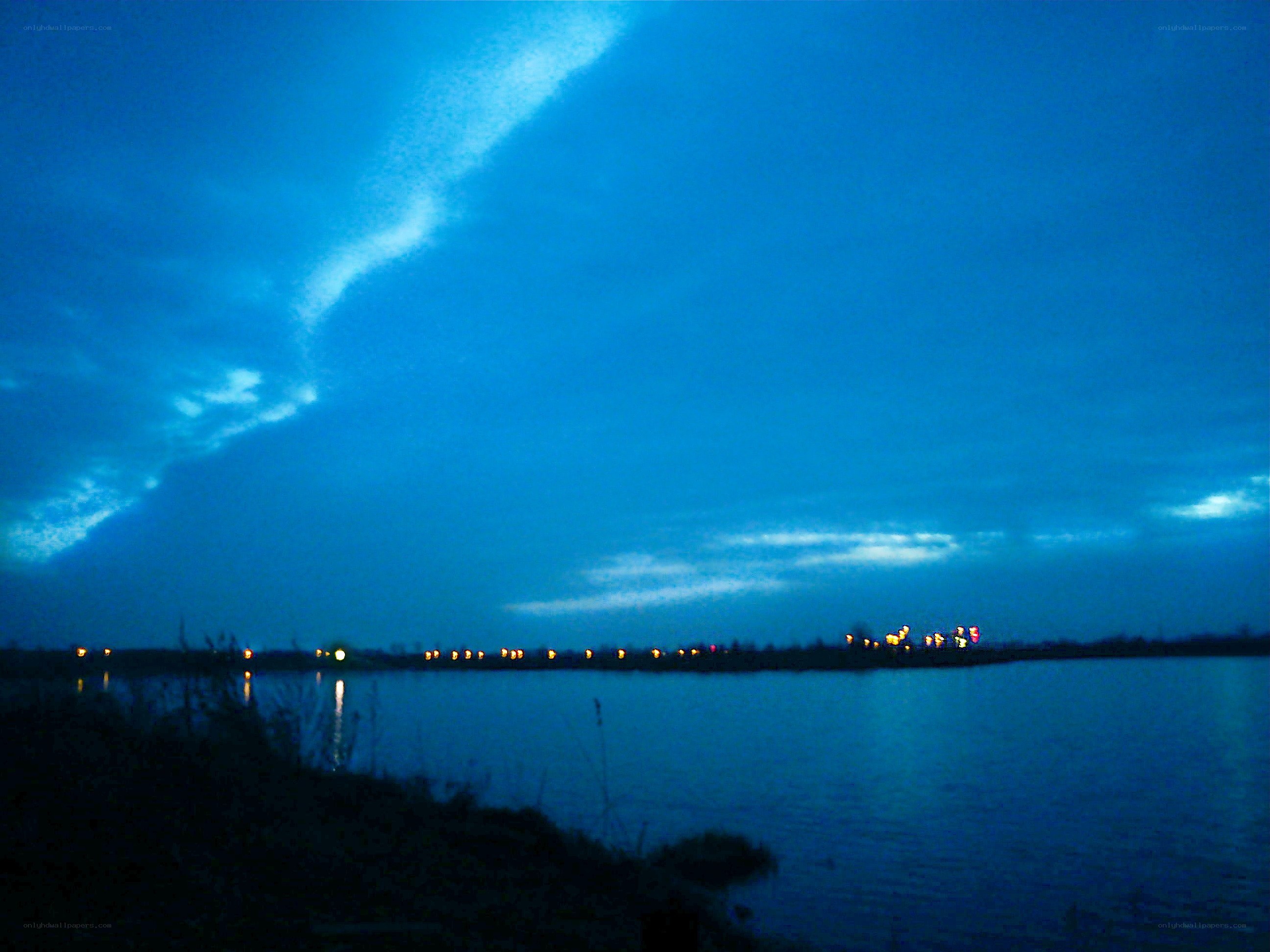 Evening lake with city lights