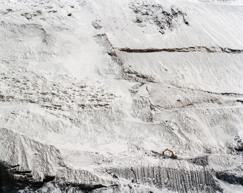 Excavator on snowy slope