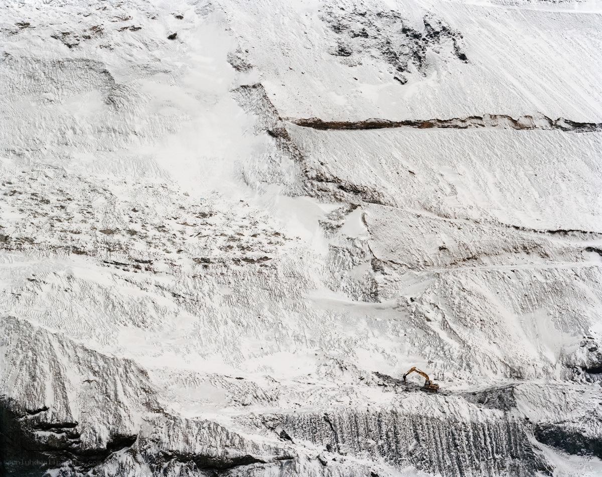 Excavator on snowy slope