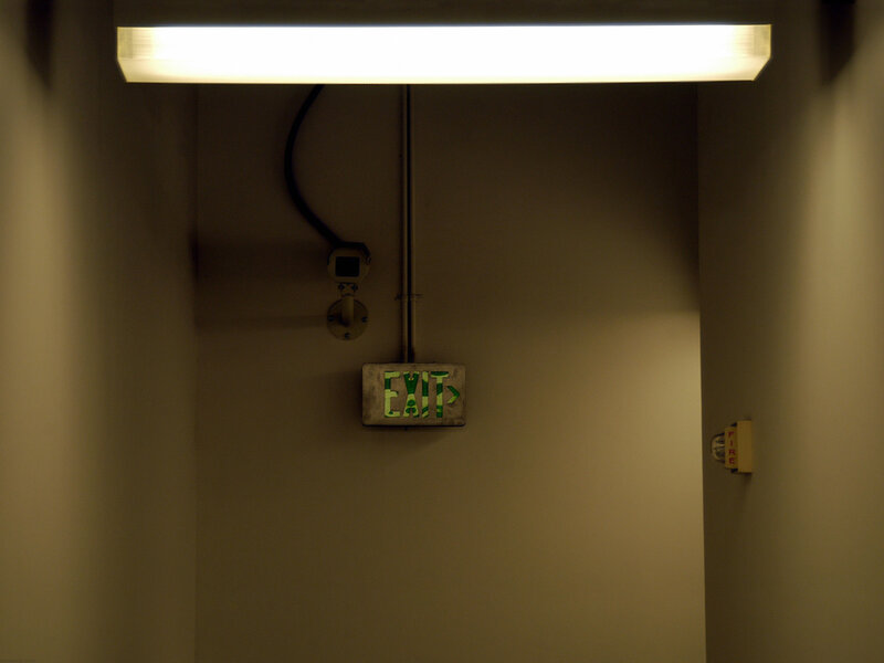 Exit sign in a dim hallway