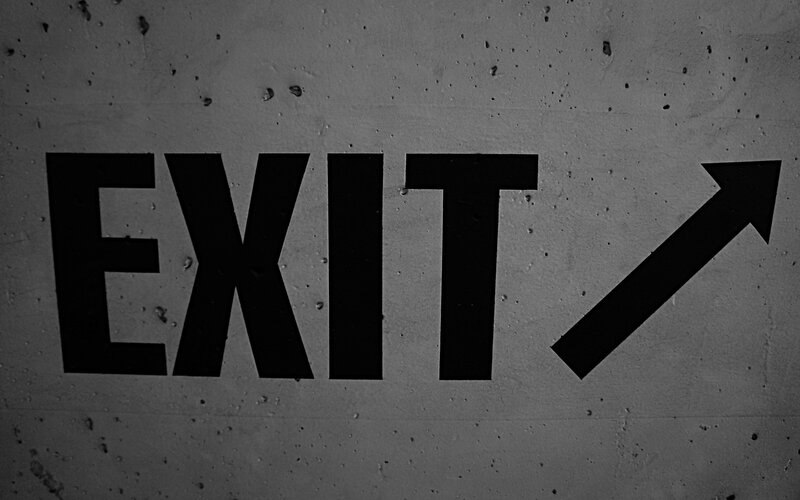 exit sign on concrete wall